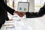 Business people colleagues shaking hands during a meeting to sign agreement for New Partner Planning